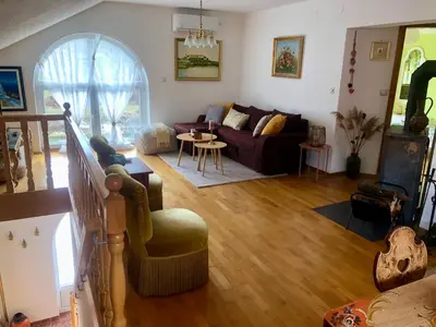 a living room with a couch and a table at Sokograd Attic in Šipovo