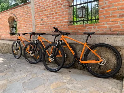 three bikes parked next to a brick wall at Sokograd Attic in Šipovo
