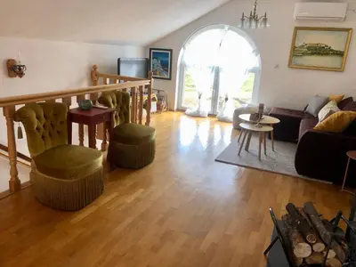 a living room with a couch and a table at Sokograd Attic in Šipovo