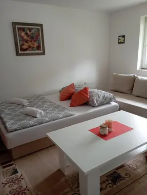 a living room with a couch and a table at Apartman U&O Bihać in Bihać