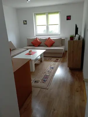 a living room with a couch and a table at Apartman U&O Bihać in Bihać