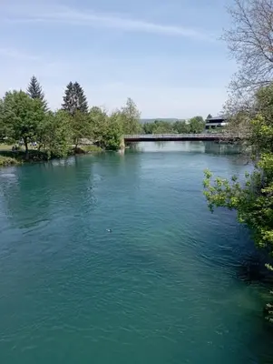 a river with a bridge in the middle of it at Apartman U&O Bihać in Bihać