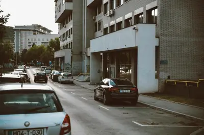 a car parked on the side of a city street at Studio apartman NEI in Tuzla