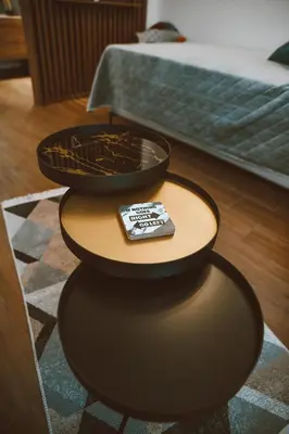 a table with a remote control sitting on top of it at Studio apartman NEI in Tuzla