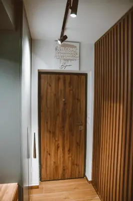 a wooden door in the corner of a room at Studio apartman NEI in Tuzla