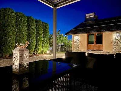 a glass table with a vase on top of it at Sunrise Guest House in Bihać
