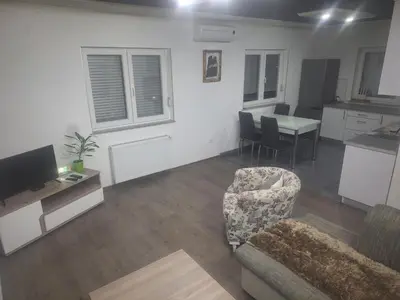 a living room with a couch and a table at Apartman Knežević in Donja Varoš