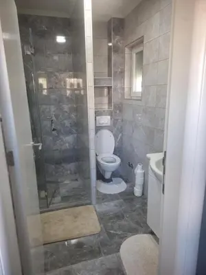 a bathroom with a toilet and a glass shower at Apartman Knežević in Donja Varoš