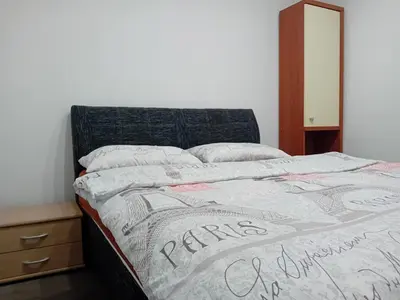 a bed in a bedroom with a bedspread and pillows at Apartman Knežević in Donja Varoš