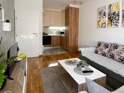 a living room with a couch and a coffee table at STENI Apartman in Doboj