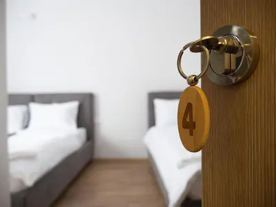 a door with a number four on it next to two beds at Motel Rezime in Zenica