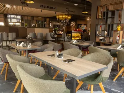 a dining room with tables and chairs in a restaurant at Motel Rezime in Zenica