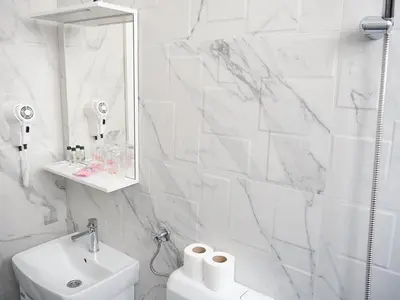 a white bathroom with a sink and a mirror at Motel Rezime in Zenica