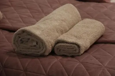 a pair of towels sitting on top of a bed at Apartman Eva in Jajce