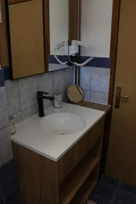 a bathroom with a sink and a mirror at Apartman Eva in Jajce