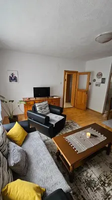 a living room with two couches and a coffee table at Apartman Naza in Kulen Vakuf