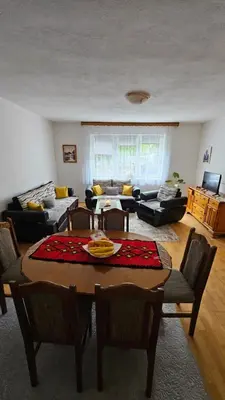 a living room with a table and chairs at Apartman Naza in Kulen Vakuf