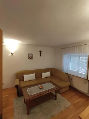 a living room with a couch and a cross on the wall at Barišić in Livno