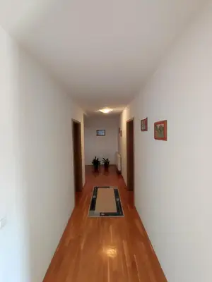 a hallway with white walls and a rug on the floor at Barišić in Livno