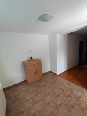 an empty room with a cabinet and a white wall at Barišić in Livno