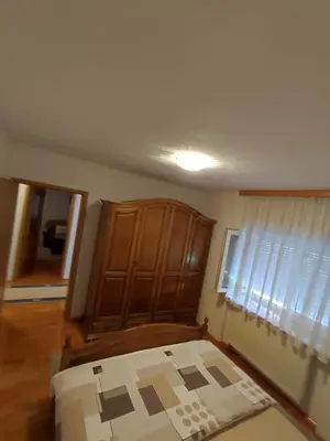 a bedroom with a bed and a cabinet and a window at Barišić in Livno