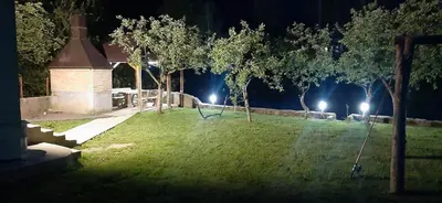 a park at night with lights in the grass at Apartman Vrbas in Jajce