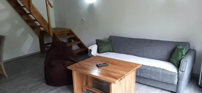 a living room with a couch and a wooden table at Apartman Vrbas in Jajce