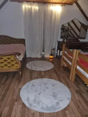 a living room with two rugs on the floor at Vikendica za odmor in Busovača