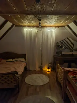 a attic room with two beds and a window at Vikendica za odmor in Busovača