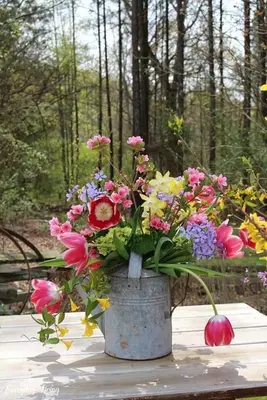 a bucket of flowers sitting on a table at Vikendica za odmor in Busovača
