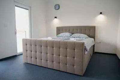 a large bed in a bedroom with a large padded mattress at CIOM Apartment in Matuzići