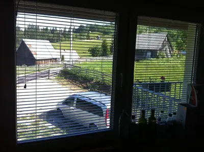 a view of a dog in a yard through a window at Apartments Baba Luce in Strica