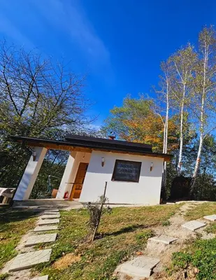 a small white house in the woods at Positive vibes in Visoko