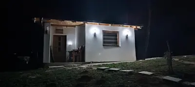 a small white house with a window at night at Positive vibes in Visoko