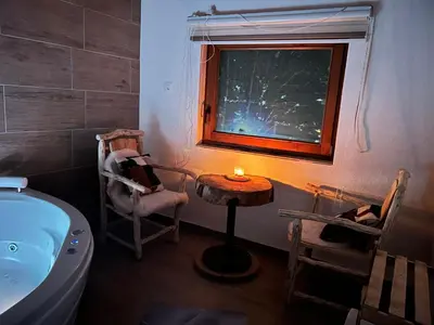 a bathroom with a table and chairs and a tub at Positive vibes in Visoko