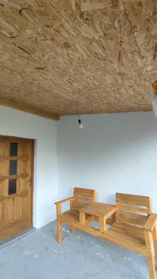 two wooden benches sitting in the corner of a room at Positive vibes in Visoko