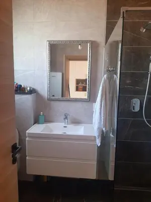a bathroom with a sink and a mirror at Vikendica Krcmarice- Banja Luka in Banja Luka