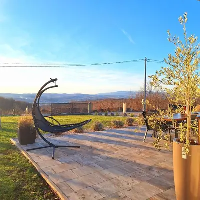 a metal sculpture of a hammock on a patio at Vikendica Krcmarice- Banja Luka in Banja Luka