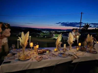 a table with plates of food and candles on it at Vikendica Krcmarice- Banja Luka in Banja Luka