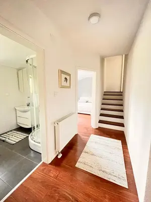 a room with a staircase and a bathroom with a sink at Apartman Stupe in Livno