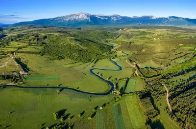an aerial view of a valley with a river and mountains at Apartman Stupe in Livno