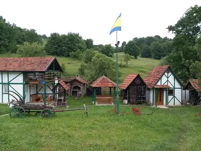 a group of small houses in a field at Kuća za odmor-Vikendica- in Visoko