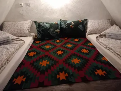 a bed with a colorful blanket on top of it at Kuća za odmor-Vikendica- in Visoko