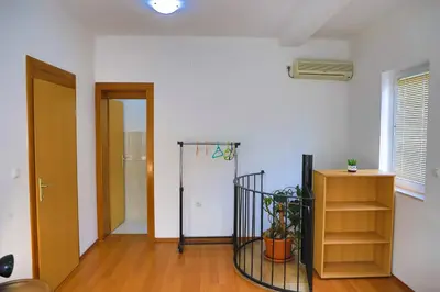 a room with a door and a shelf with a plant at APARTMAN NAAJ in Bihać