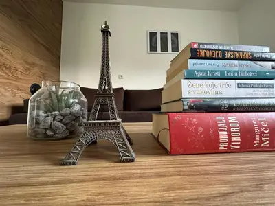 a miniature eiffel tower sitting on top of books at Sara in Jajce