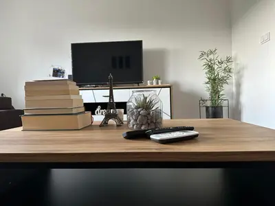 a desk with a remote control and books on it at Sara in Jajce