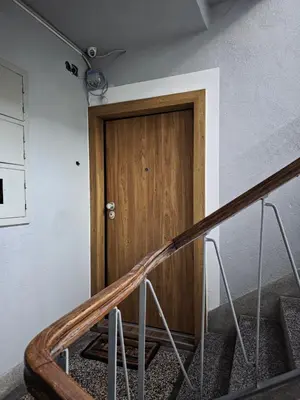 a wooden door in a room with stairs at Sara in Jajce