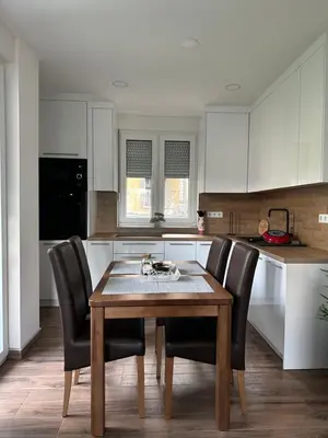 a kitchen with a wooden table and black chairs at Sara in Jajce
