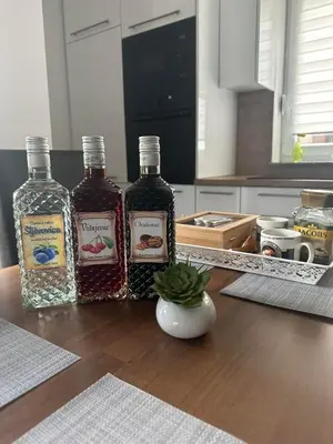 three bottles of alcohol on a table in a kitchen at Sara in Jajce