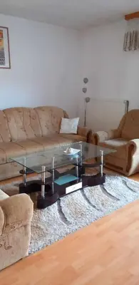 a living room with a couch and a glass table at Ferienwohnung Sabina in Bosanska Krupa